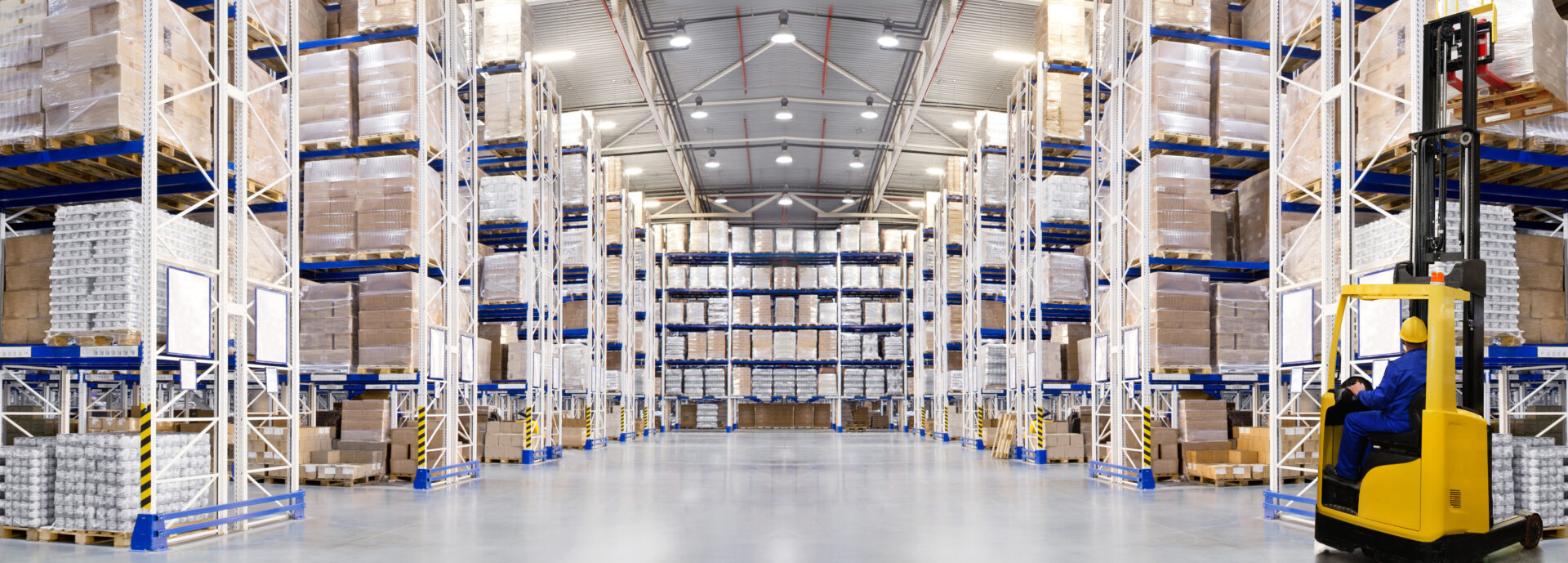 Huge distribution warehouse with high shelves and forklift. Bottom view.