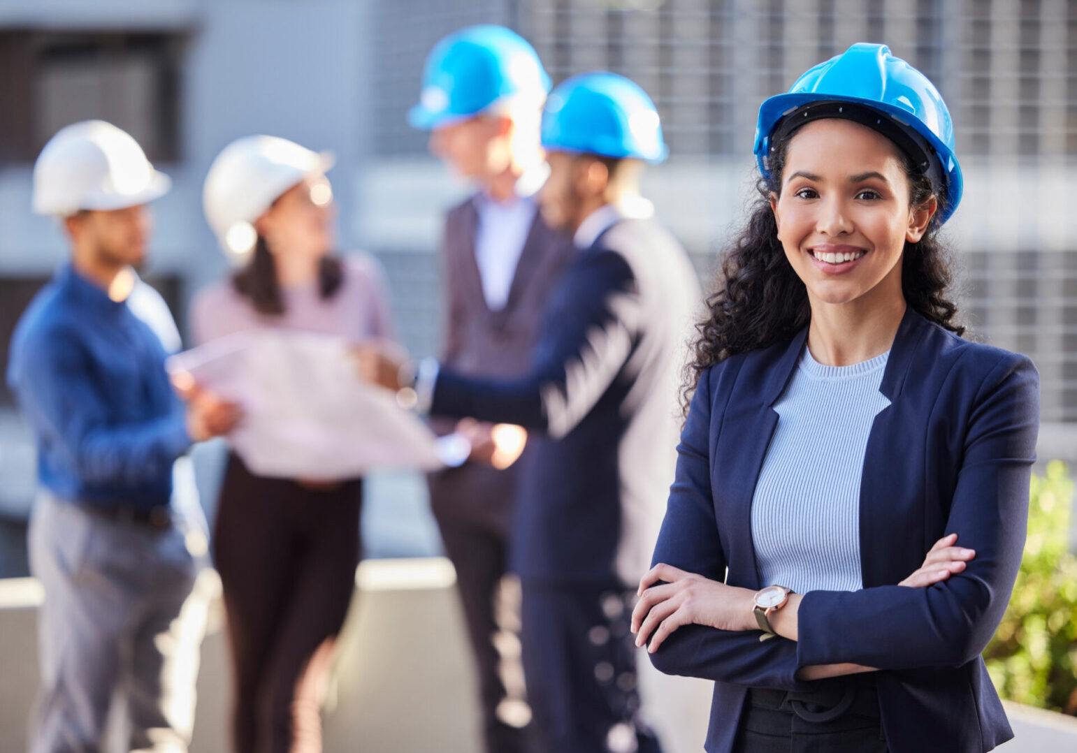 Happy woman, portrait and architect in construction, leadership or team management with arms crossed on site. Confident female person, engineer or manager with hard hat for industrial architecture.